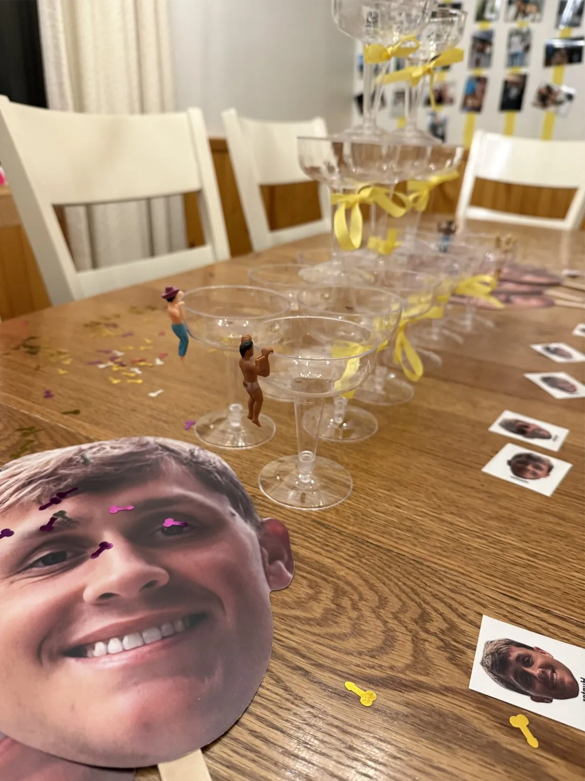 A champagne tower built from plastic coupes tied with yellow ribbon