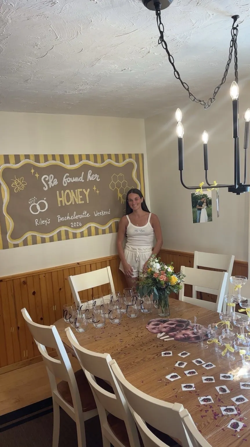 A hand-painted “She Found Her Honey” banner above the dining table